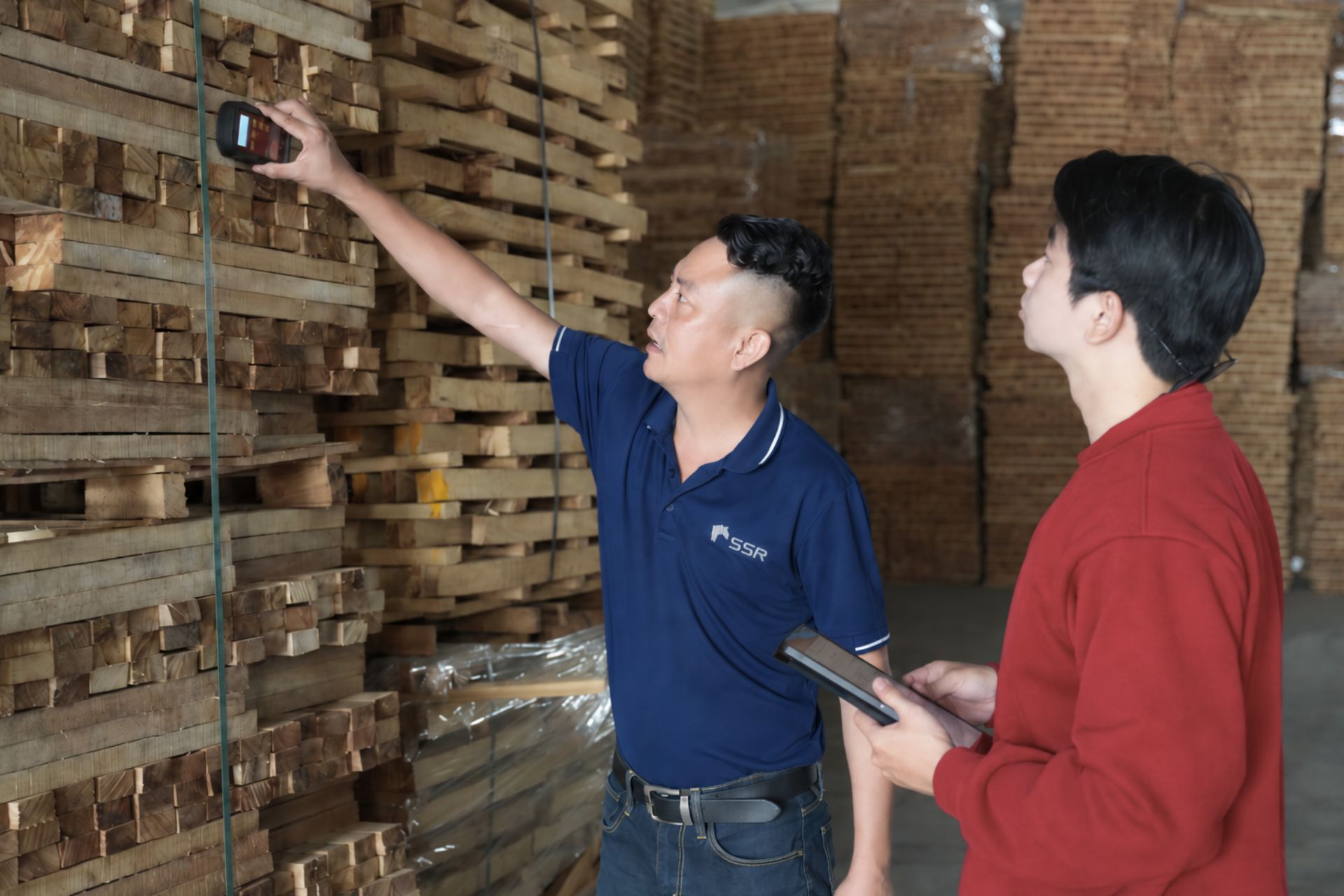 Why a Factory Tour Matters When Choosing a Wood Manufacturing Partner? Moisture testing during a factory tour at a wood factory