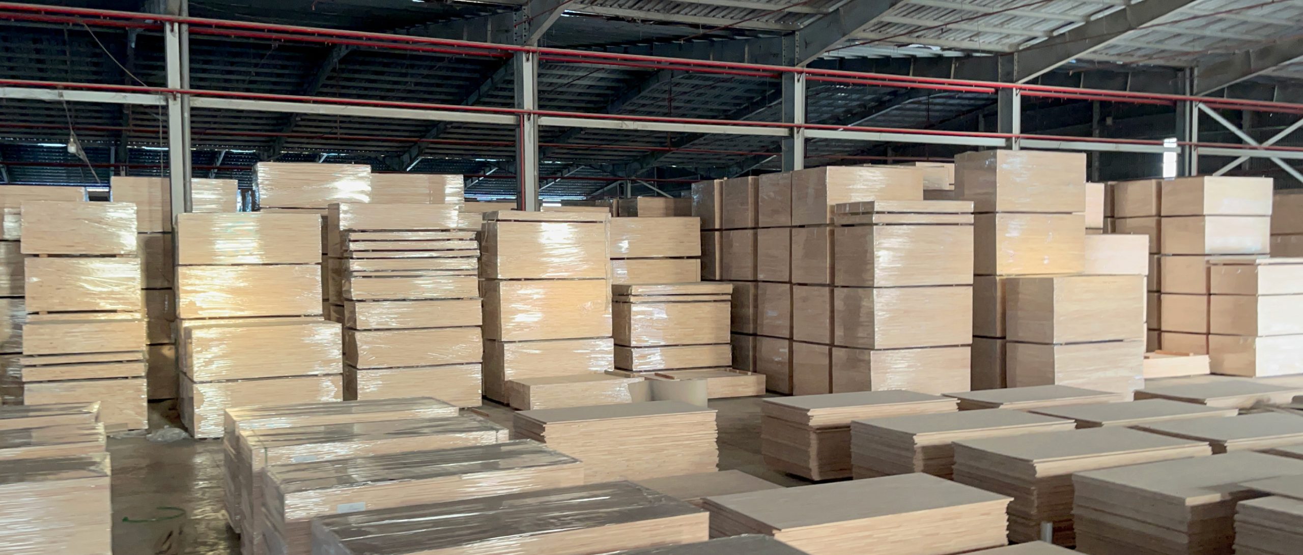 Reviewing a solid wood board during a visit to SSR's wood factory in Vietnam